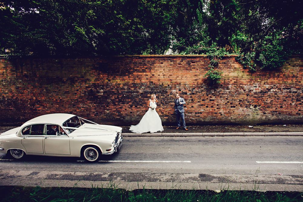 couple flagging down bridal car
