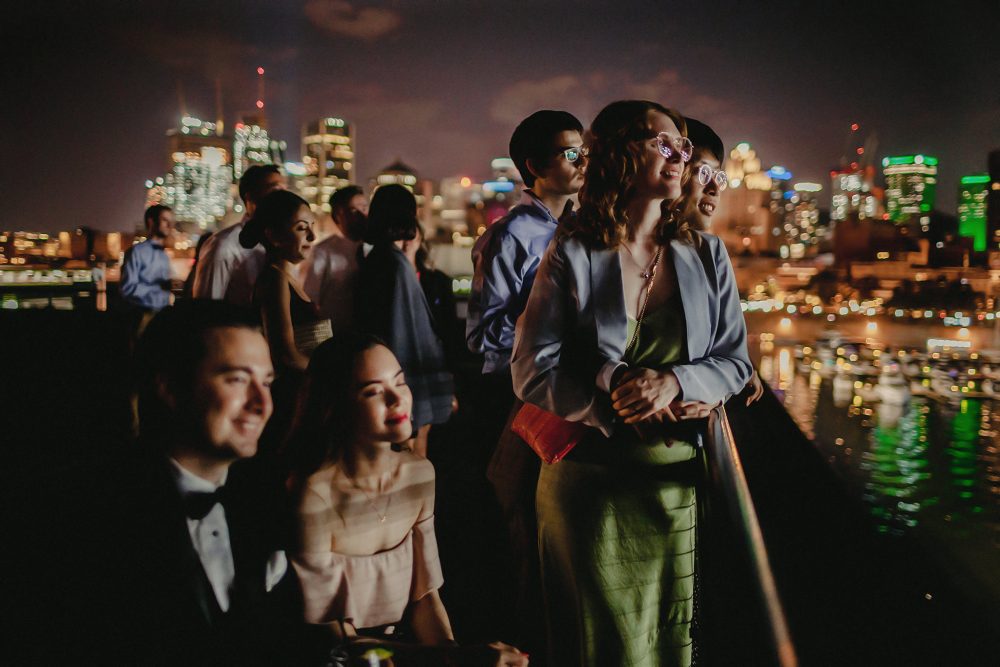 wedding guests at t night with montreal skyline