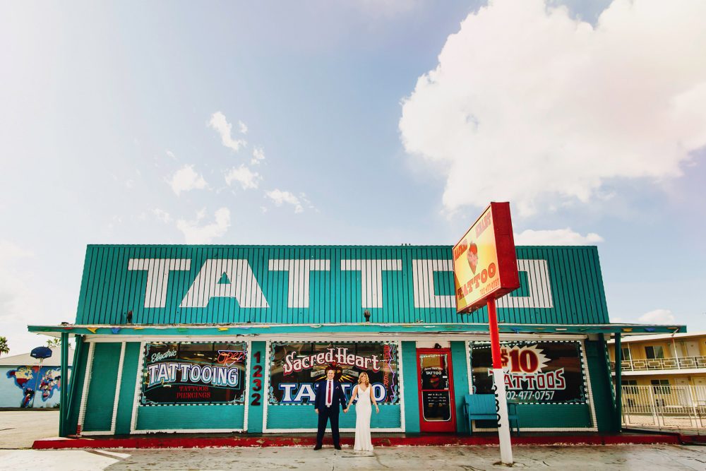 bride and groom in front of Las Vegas tattoo store