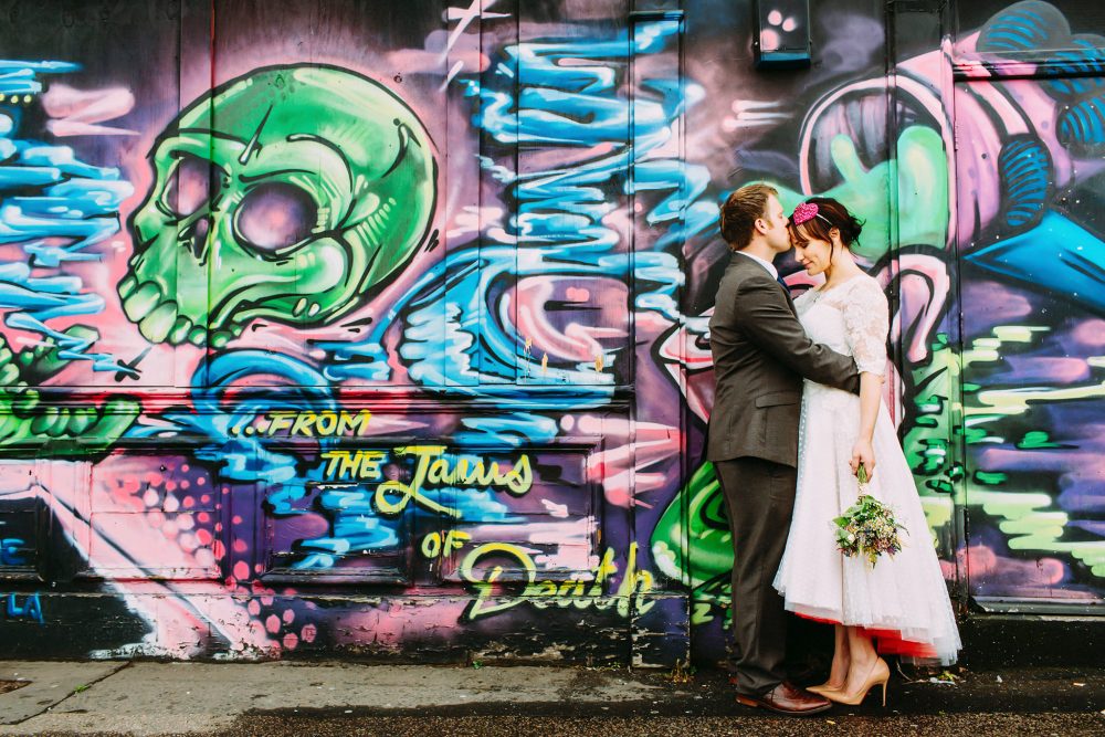 graffiti wall with bride in vintage style dress