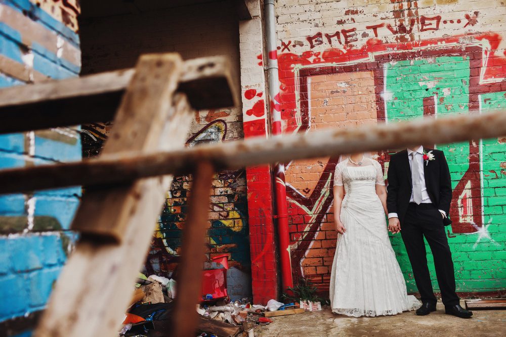 quirky wedding portrait with graffiti