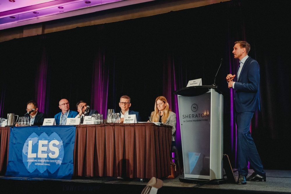 A panel of people listening to a speaker.