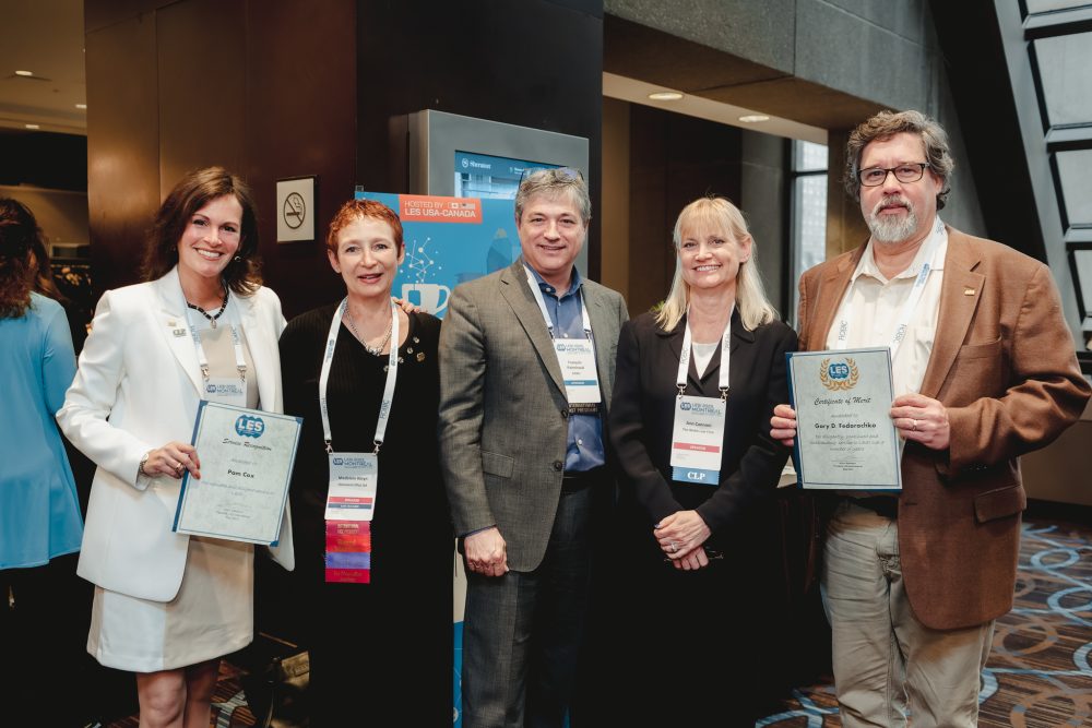 A group of people showing their certificates.