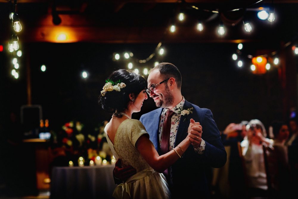 Couple enjoying their first dance in a dimly lit room