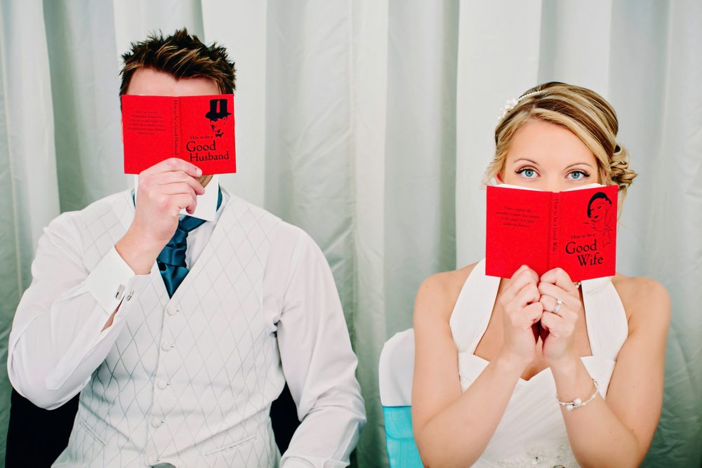 bride and groom hide behind self help books