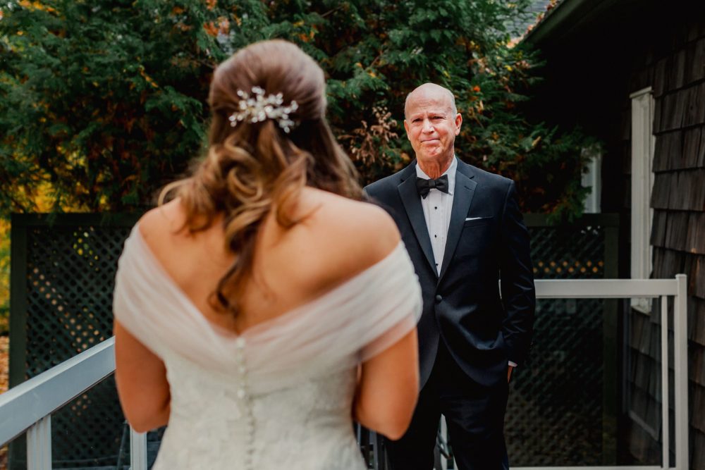 A bride's father sees gets emotional when he sees her in her dress